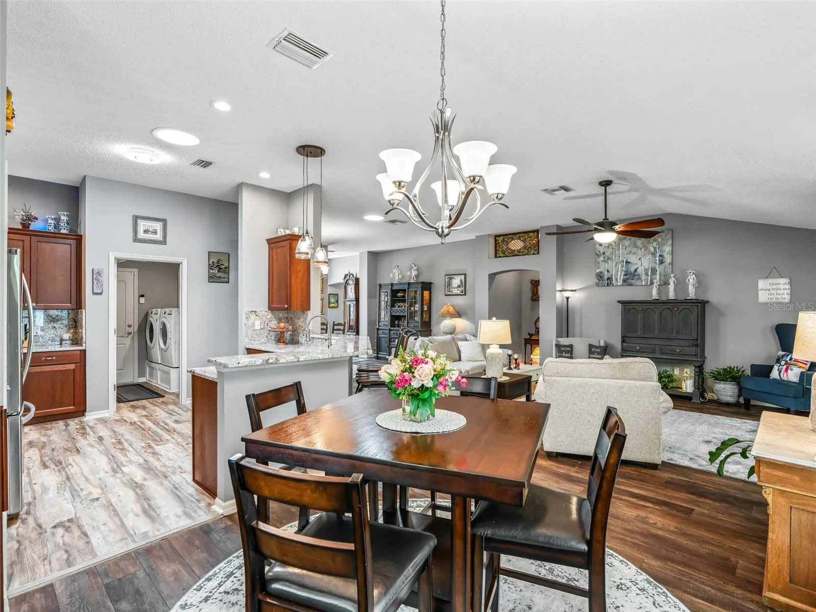 The centrally located dining area offers an easy flow to the kitchen and living room, creating a comfortable setting for meals and entertaining.