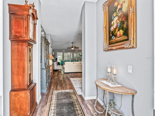 A long, inviting foyer with attractive wood-look High-end LVP flooring provides a clear sightline into the home’s open living spaces.
