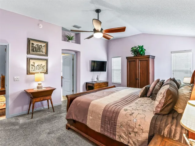 The spacious primary bedroom provides room for a king-size bed, dressers, a sitting area, and additional furnishings without feeling crowded.