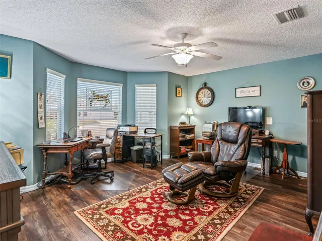 Spacious bonus room offers abundant natural light, wood-look flooring, a ceiling fan, and plenty of space for a home office, hobby room, 2nd Guest Bedroom, or additional sitting area.