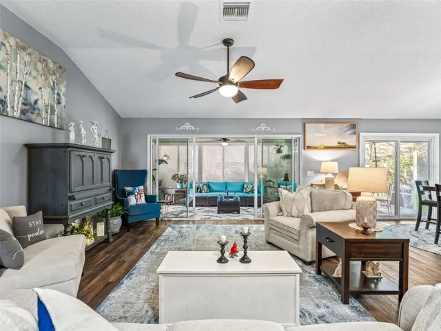 Large windows and sliding glass doors brighten the main living area while providing a pleasant view toward the enclosed rear living space.