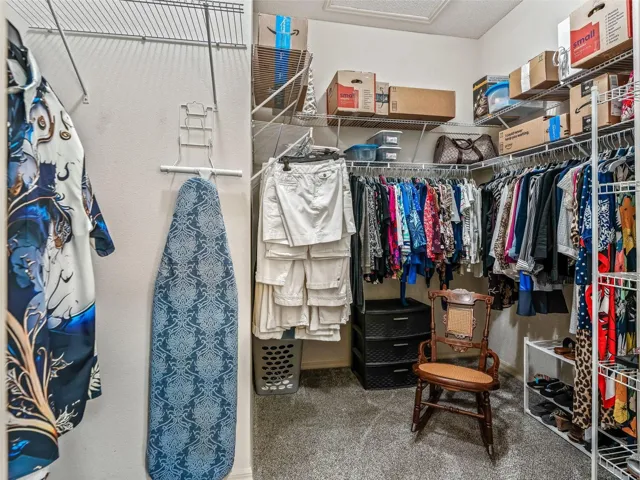 Roomy walk-in closet features extensive shelving and hanging space, providing excellent storage for clothing, shoes, and accessories.