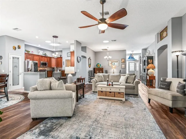 View from the living room showcases the home’s flowing layout, connecting the kitchen, dining area, and main gathering space for effortless entertaining.