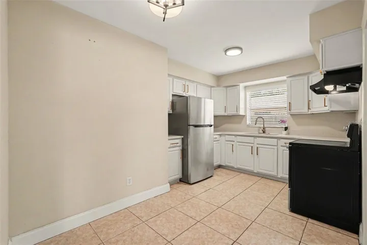 The kitchen is both stylish and functional, with plenty of cabinet and counter space.