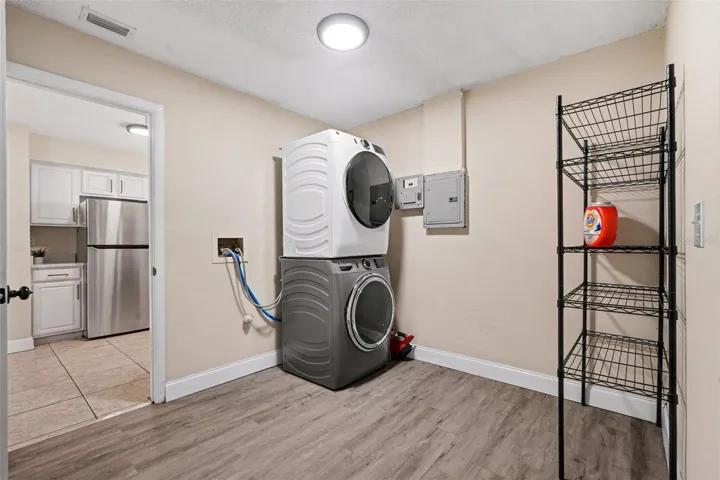 An oversized inside laundry room provides extra storage and everyday convenience.