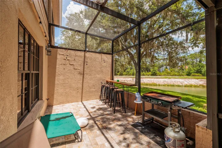 screened in porch with lake view