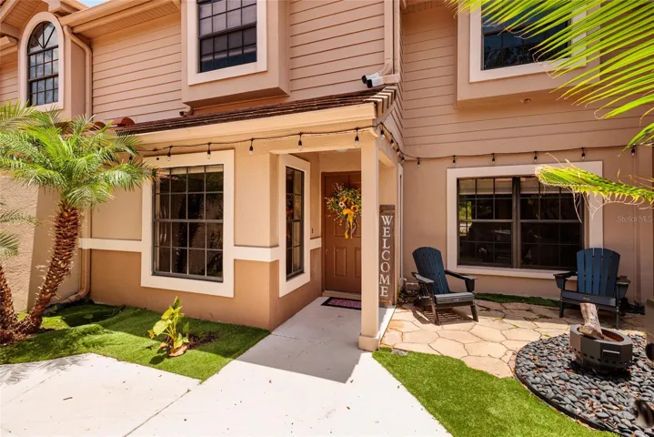 Front with patio, fire pit, and front door