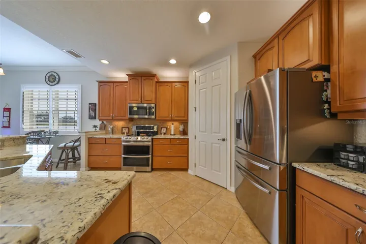 The open concept ensures that you are always a part of the action.  Notice the drawers next to the double oven and the bright lights for easy cooking.