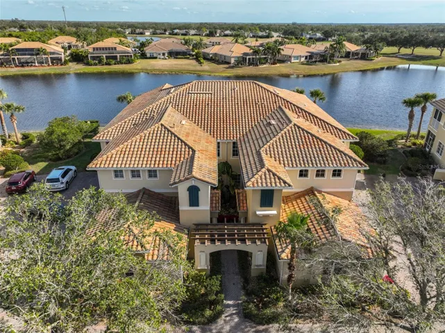 Mediterranean style, water front, first floor luxury condo is now available and even has extra parking space, due to being on the curve!