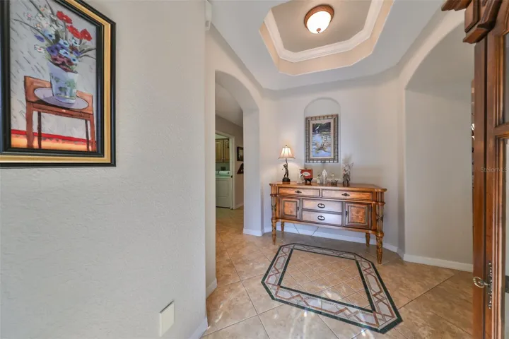 Notice the trey ceiling, architectural niche and custom medallion in the front foyer.