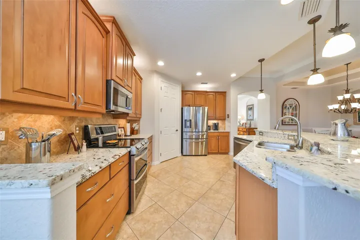 The kitchen boasts of modern granite, custom 42