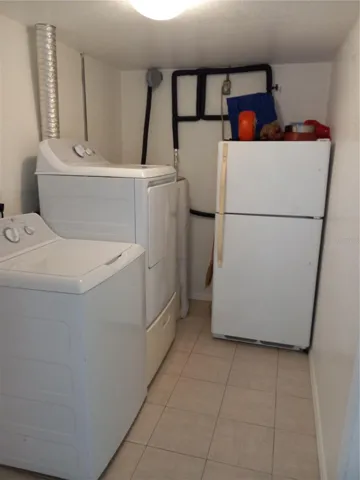 6 x 10 laundry room connects from garage to kitchen,  extra refrigerator stays