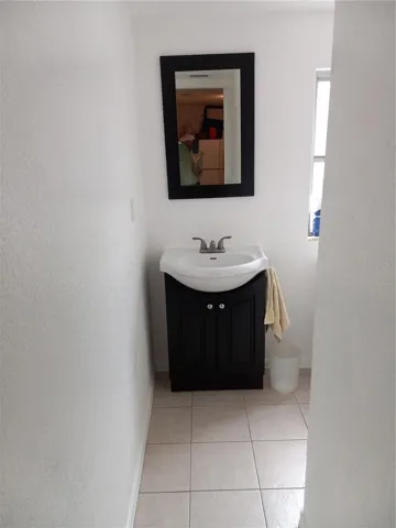 3 piece 2nd bath with shower stall, updated toilet and vanity, off laundry room