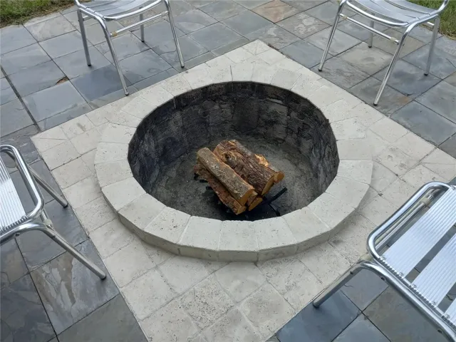cement inground firepit on slate floor patio