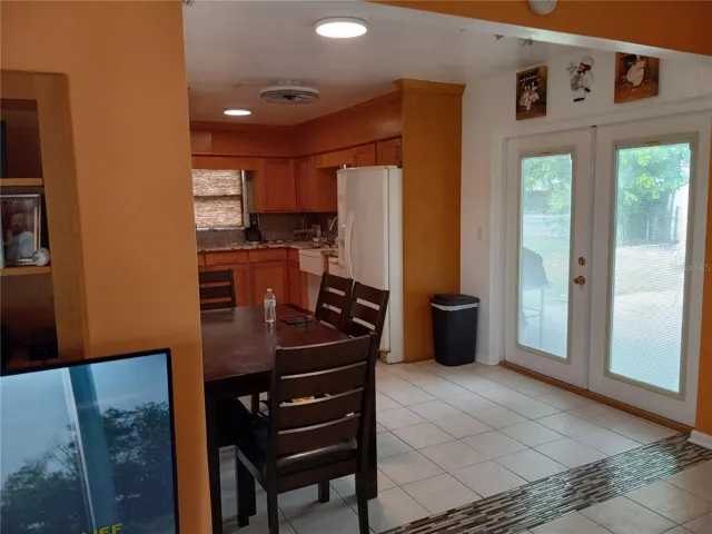 looking into eating area with french doors out to covered 10 x 14 patio with beautiful Slate tile floor and built in cement fire pit