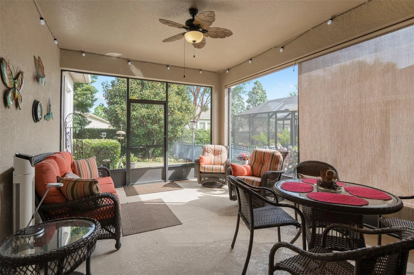 The Screened Under Roof Lanai offers a great view of the rear yard and has roller shades on one side.