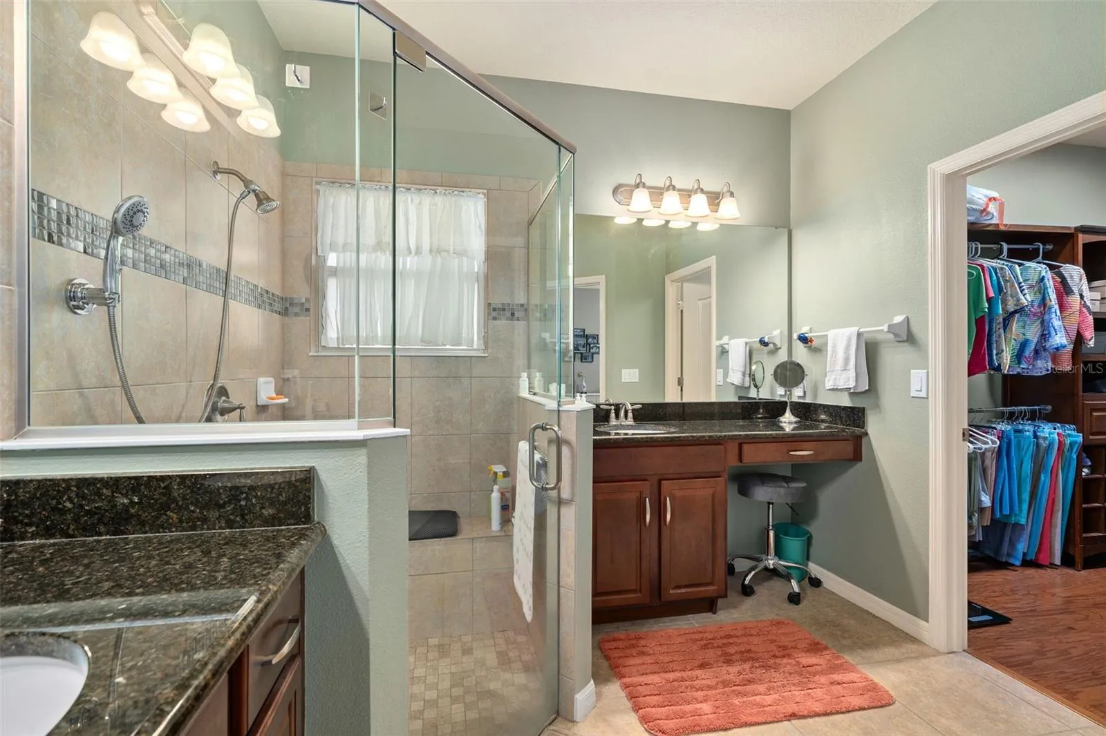 Primary En-Suite offers Walk-In Shower with a Seat and a Walk-In Closet with Organizers.