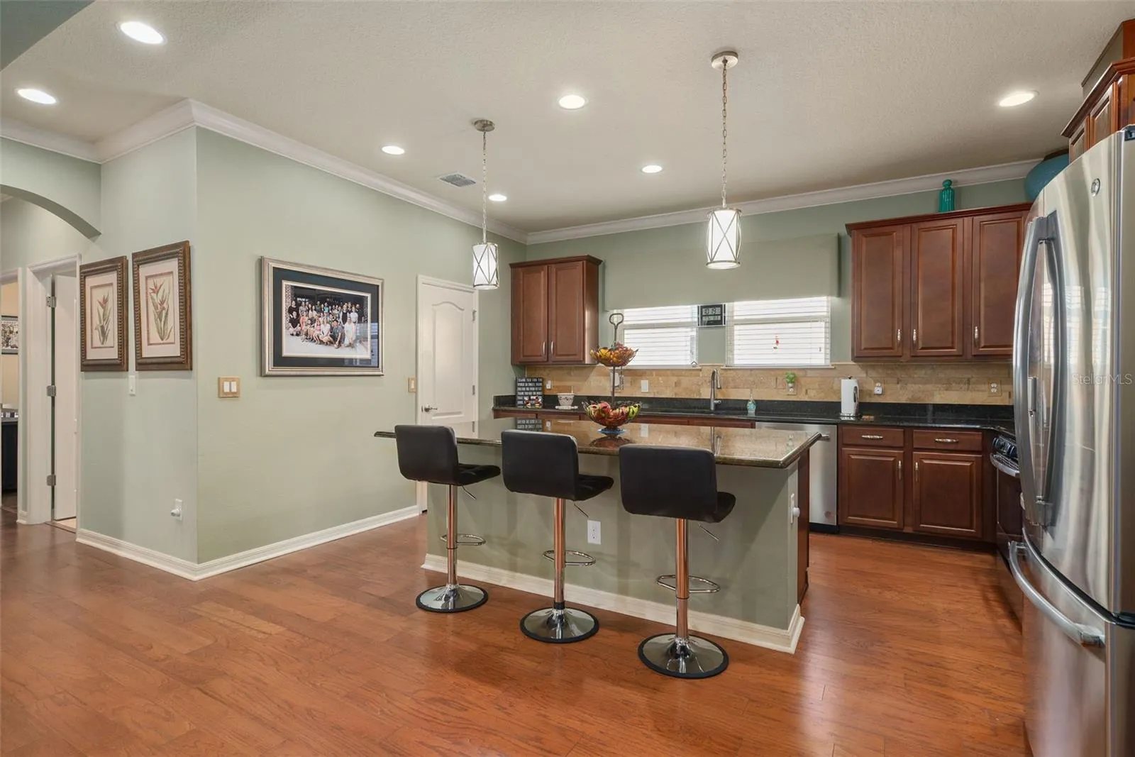 Plenty of cabinets and counter prep area is complimented by the island/Breakfast Bar and a Large Walk-in Pantry.