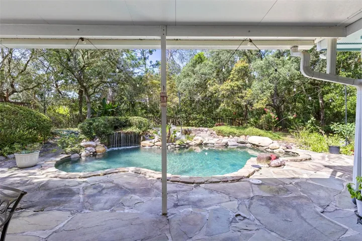 Unscreened covered patio for extra entertaining straight out of the pool