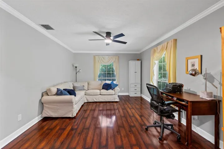 Oversized formal living room with tons of natural light filtering in