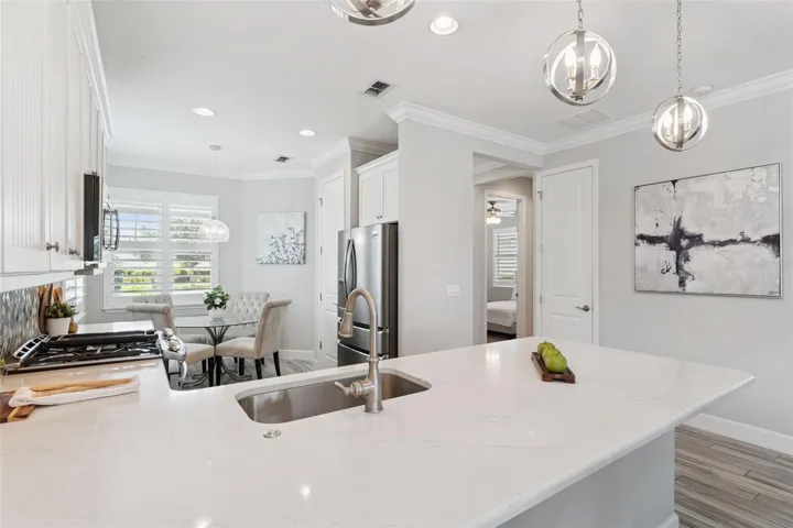 Single basin Kitchen sink & spacious breakfast bar w/ pendant lighting