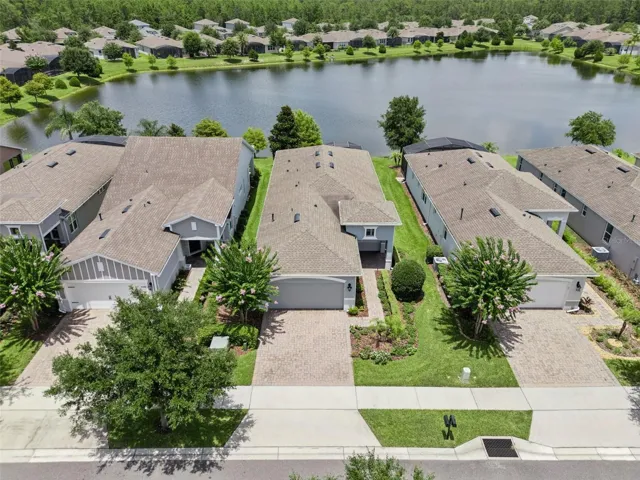 Aerial view of the home w/ a Pond view