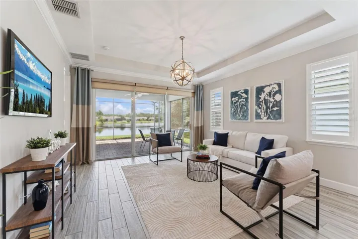 15' x 15' Great Room w/ tray ceiling, Plantation style shutters & remote controlled shades for sliding glass doors