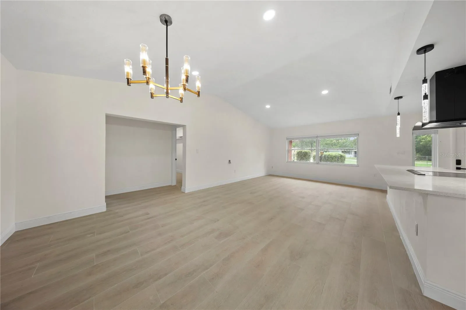 Hallway leads to patio access, Bedroom 3 on the left, and laundry room/garage access on the right.