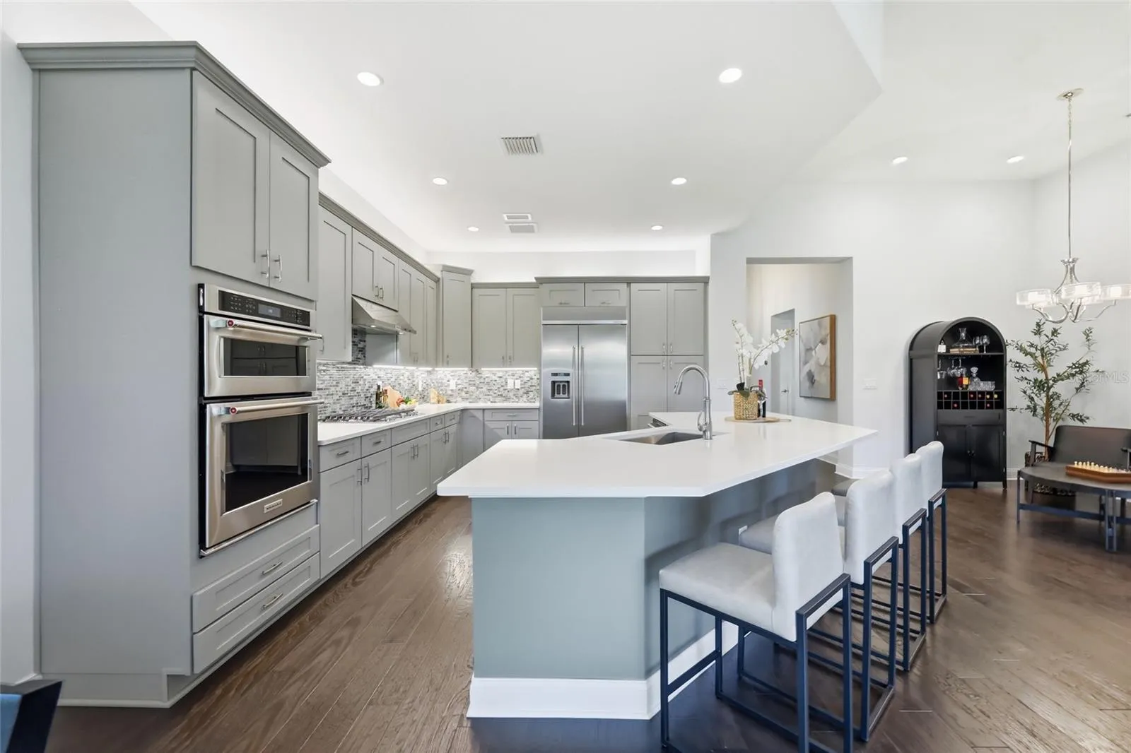 Thoughtfully Designed Kitchen with Built-in Pantry Drawers, Counter Depth Smudge Proof Refrigerator, Accent Lighting, and Lazy Suzan Corner Cabinets to Maximize Space