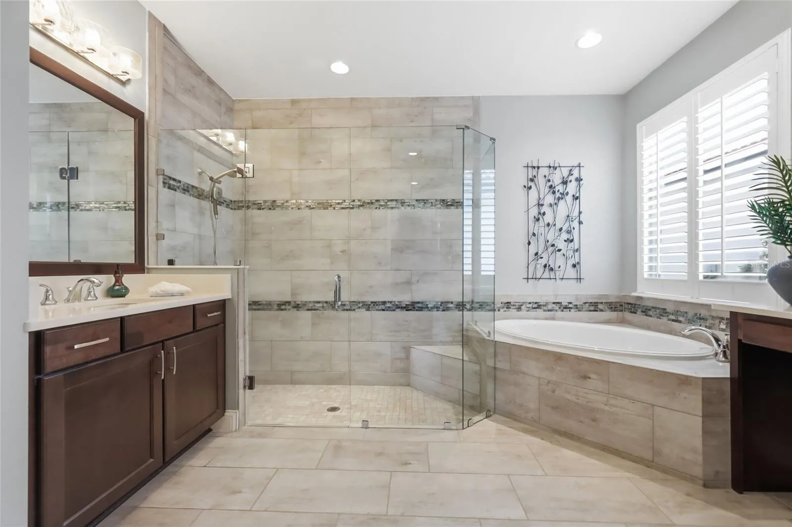 Primary En-suite: Floor to ceiling shower tiles, soaking tub and dual vanities
