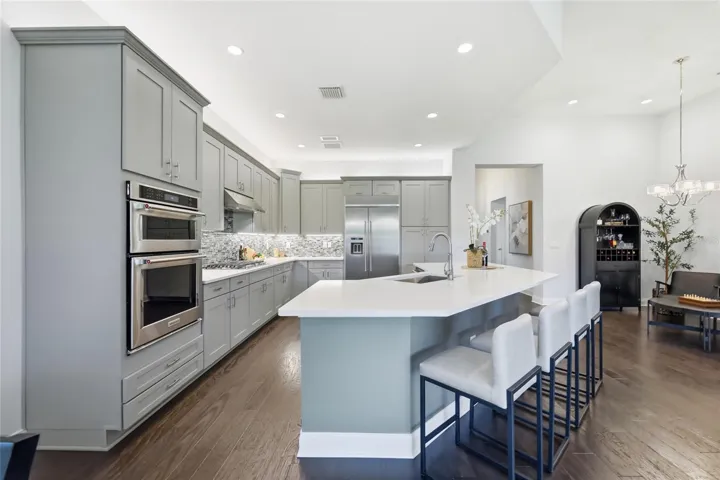 Thoughtfully Designed Kitchen with Built-in Pantry Drawers, Counter Depth Smudge Proof Refrigerator, Accent Lighting, and Lazy Suzan Corner Cabinets to Maximize Space