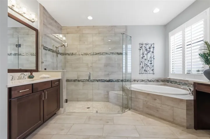 Primary En-suite: Floor to ceiling shower tiles, soaking tub and dual vanities