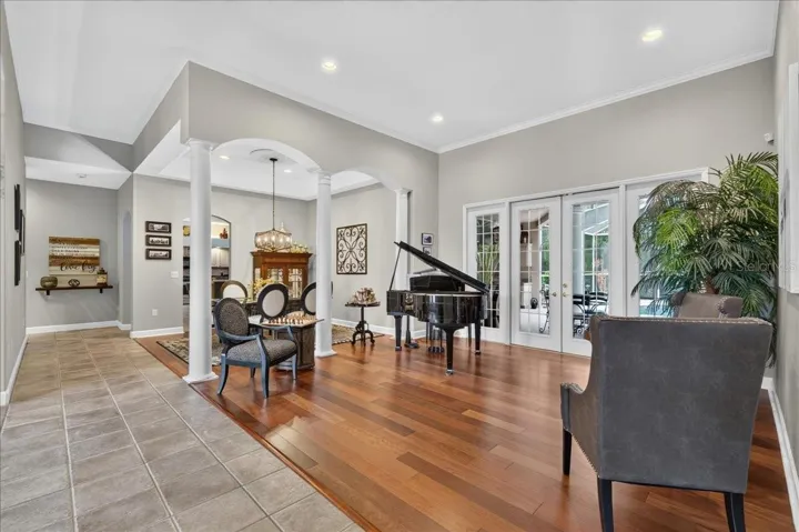 Past the foyer, decorative columns frame the formal living and dining rooms, where 10-foot tray ceilings and generous proportions create an impressive setting for gatherings.