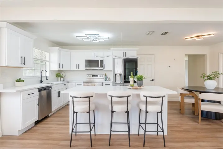 Modernized Kitchen, this quartz topped island is ready to host your morning nosh and your evening parties!