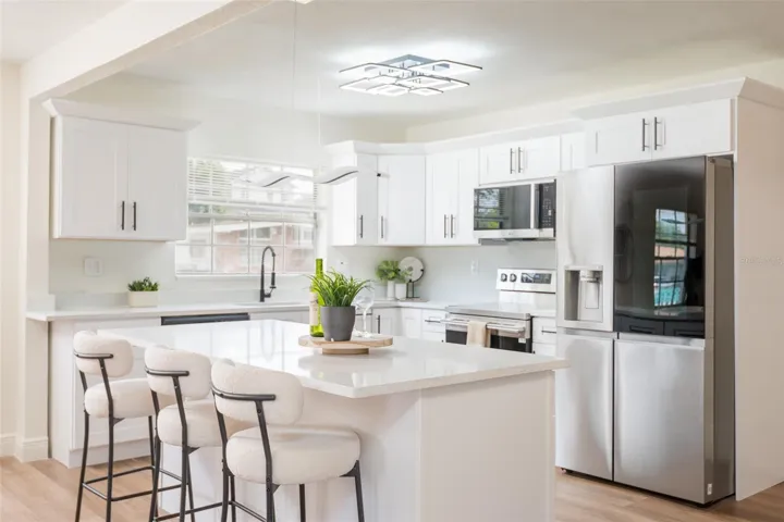 Modernized Kitchen, this quartz topped island is ready to host your morning nosh and your evening parties!