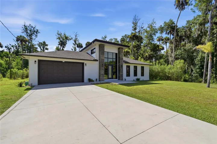 Oversized two-car garage with ample driveway parking.