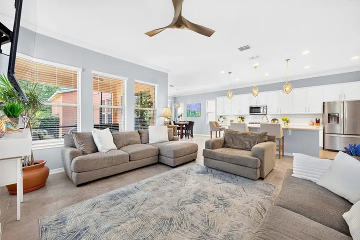 The spacious Living Room creates a stunning impression with its custom STACKED STONE ACCENT WALL with sleek electric fireplace, creating a warm yet contemporary gathering space.