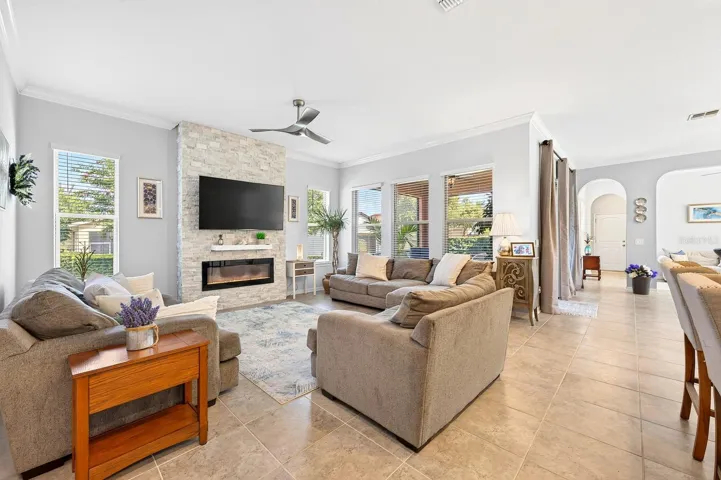 Step inside to discover an open floor plan where elegant CERAMIC TILE FLOORING, fresh interior paint (2021), and crown molding (2021) create a refined backdrop for everyday living.