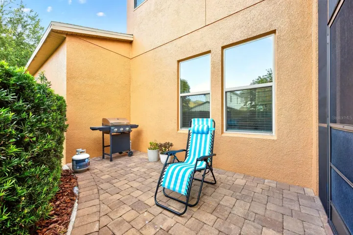 The adjoining open-air patio provides an ideal space for grilling, dining under the stars, or soaking up the Florida sunshine.