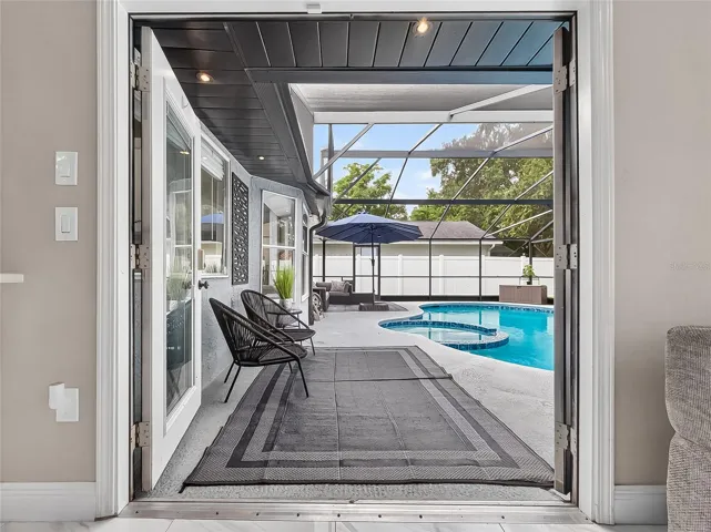 French Doors Open from Family Room to Screened-in Pool
