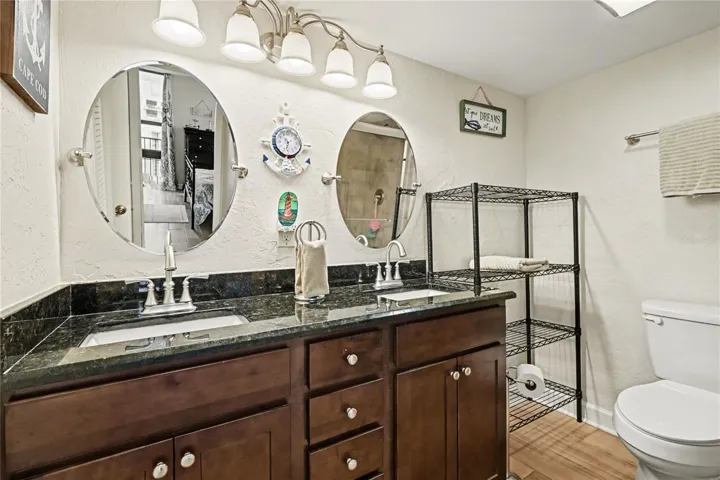 Primary bath with granite countertops and double vanites,