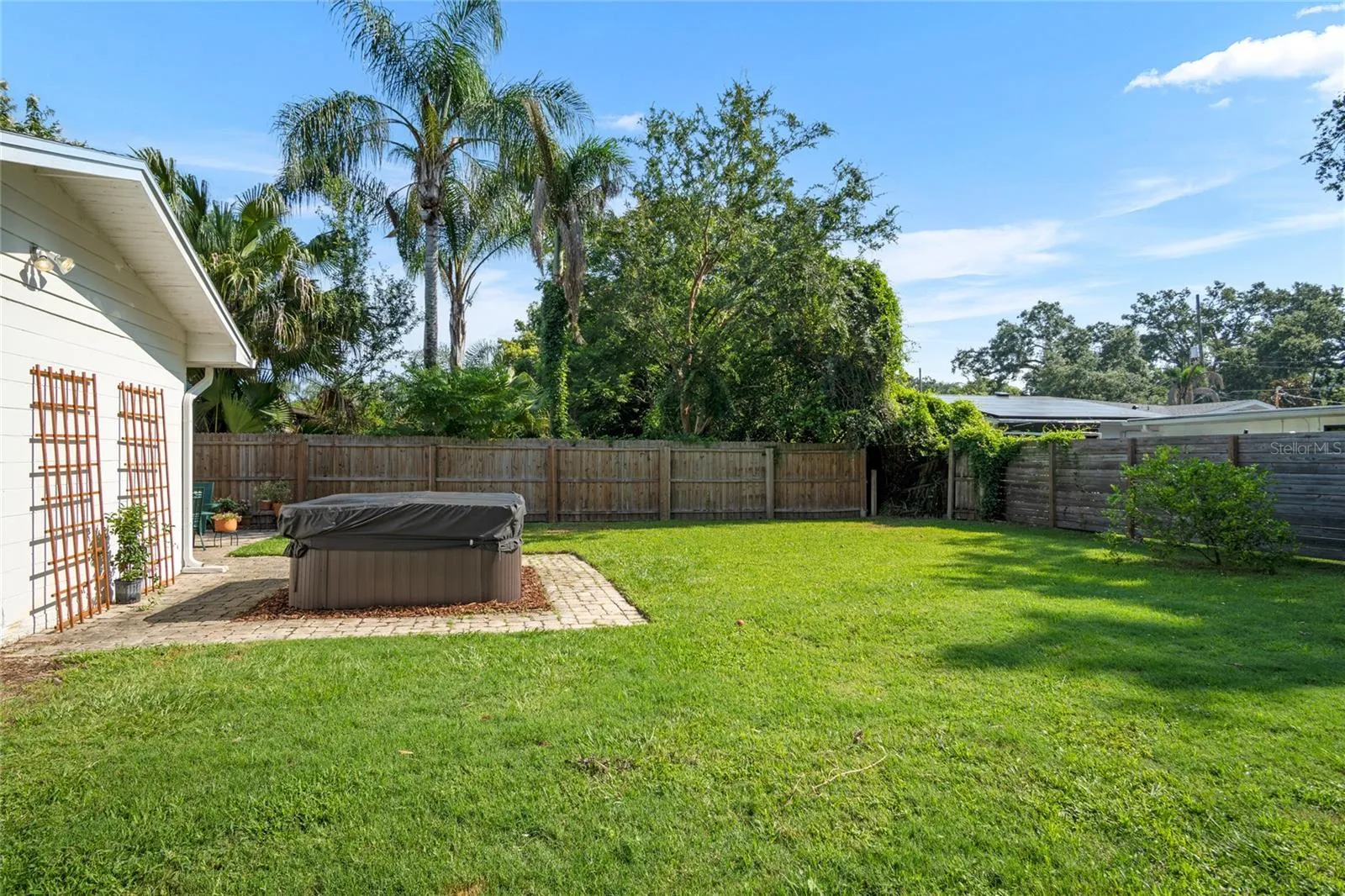 Looking toward the south with a view of the great sized back yard including the hot tub.
