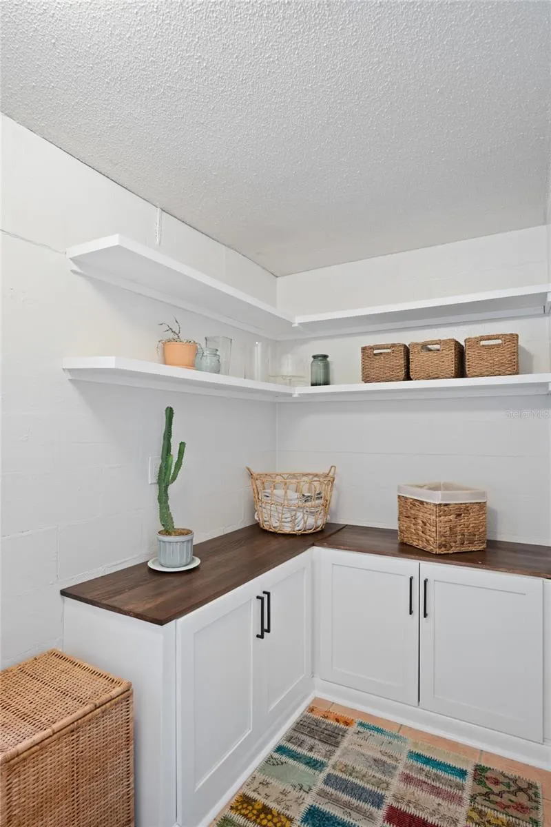 The laundry room has great storage and a work area.