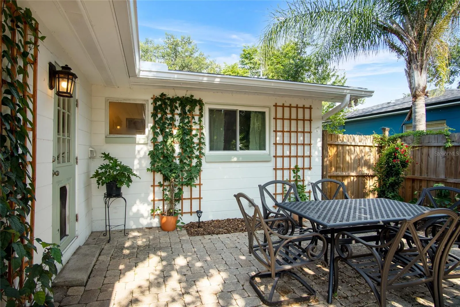 An inviting patio is a great place to have a meal or just relax under the crepe myrtle.