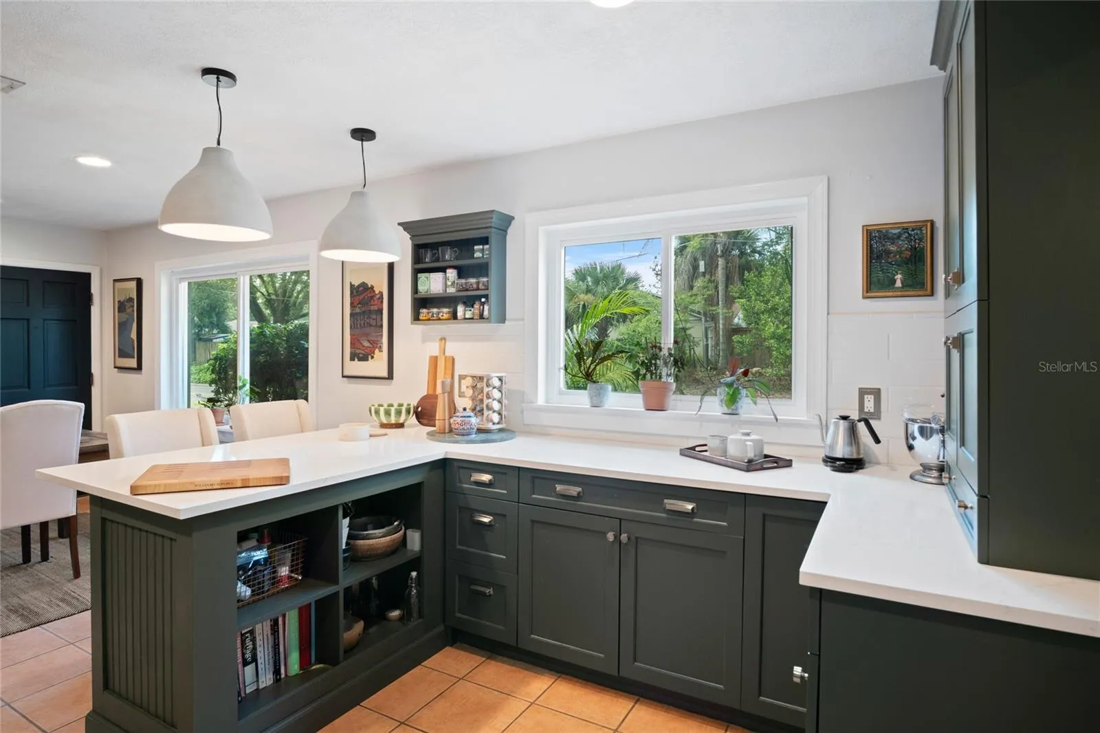 Plenty of light from the recessed lighting, double pane windows, and the pendant lights.