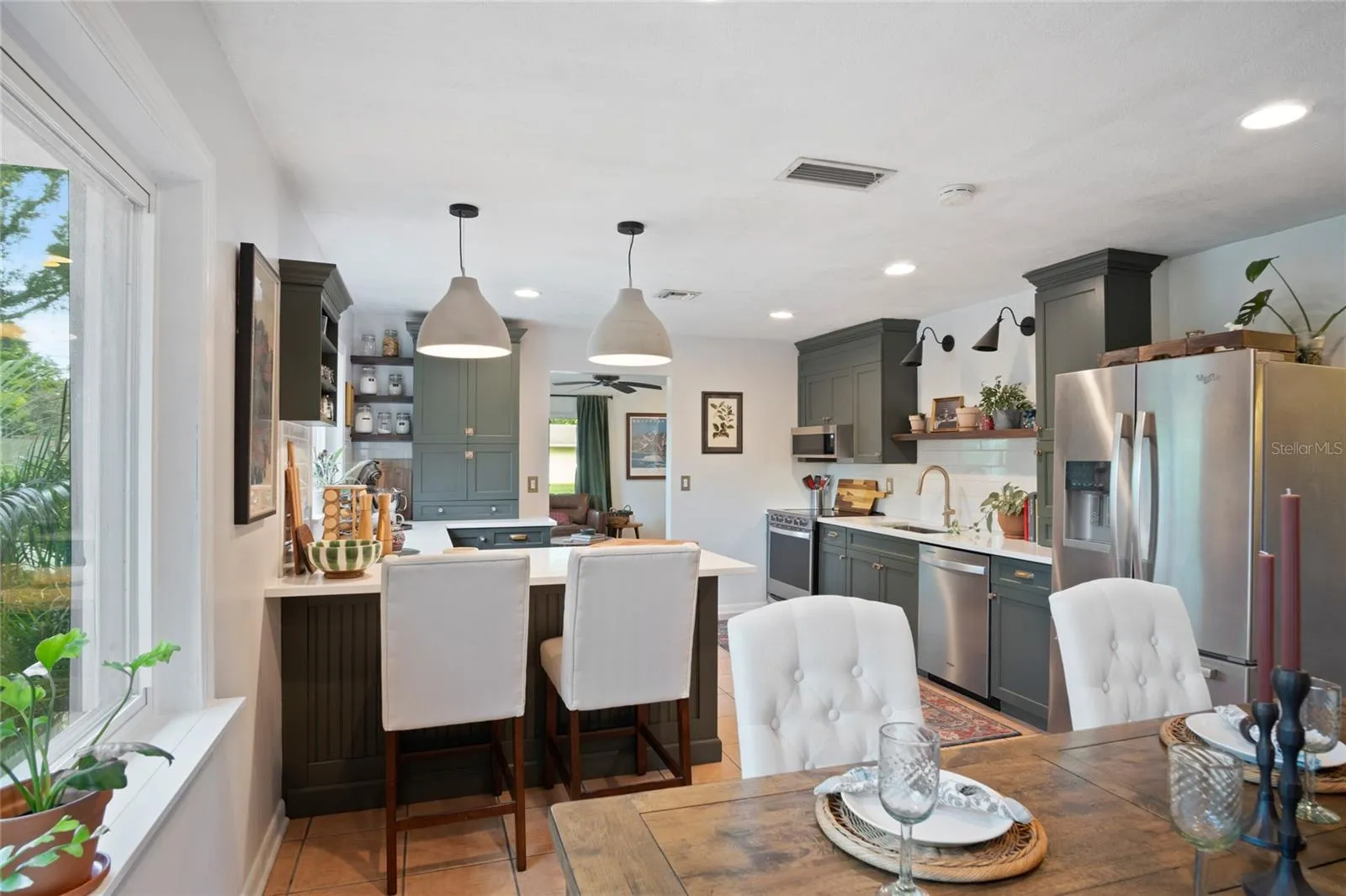 You'll notice the room in the dining area and the breakfast bar for gathering the family or guests to have a wonderful meal.