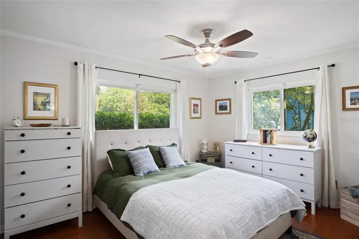 The primary bedroom is light and bright with windows looking out to the west and to the north.