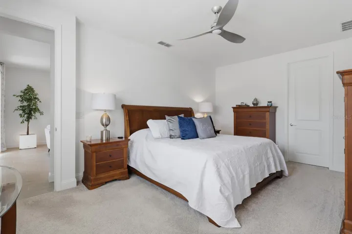The spacious primary bedroom can house large sets of furniture. Their is also a large walk-in closet in the room.