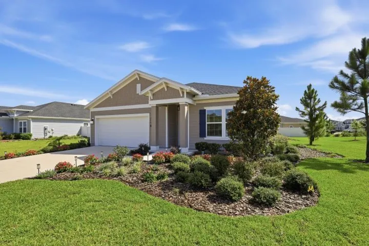 Lush green yard and beautiful flowers and landscaping greets you.