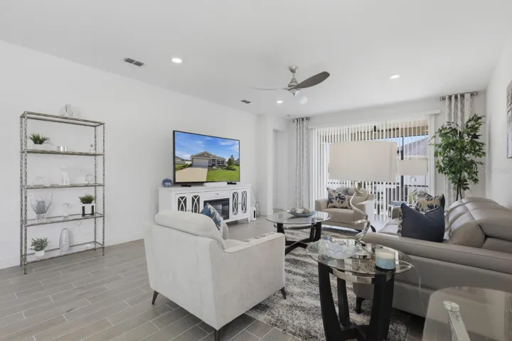 Featuring a custom ceiling fan and blinds over the rear sliding glass door for privacy.